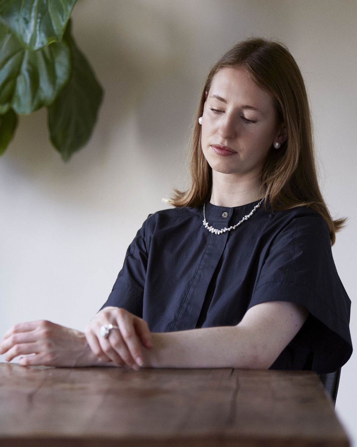 Woman sitting at a table with a blurred background