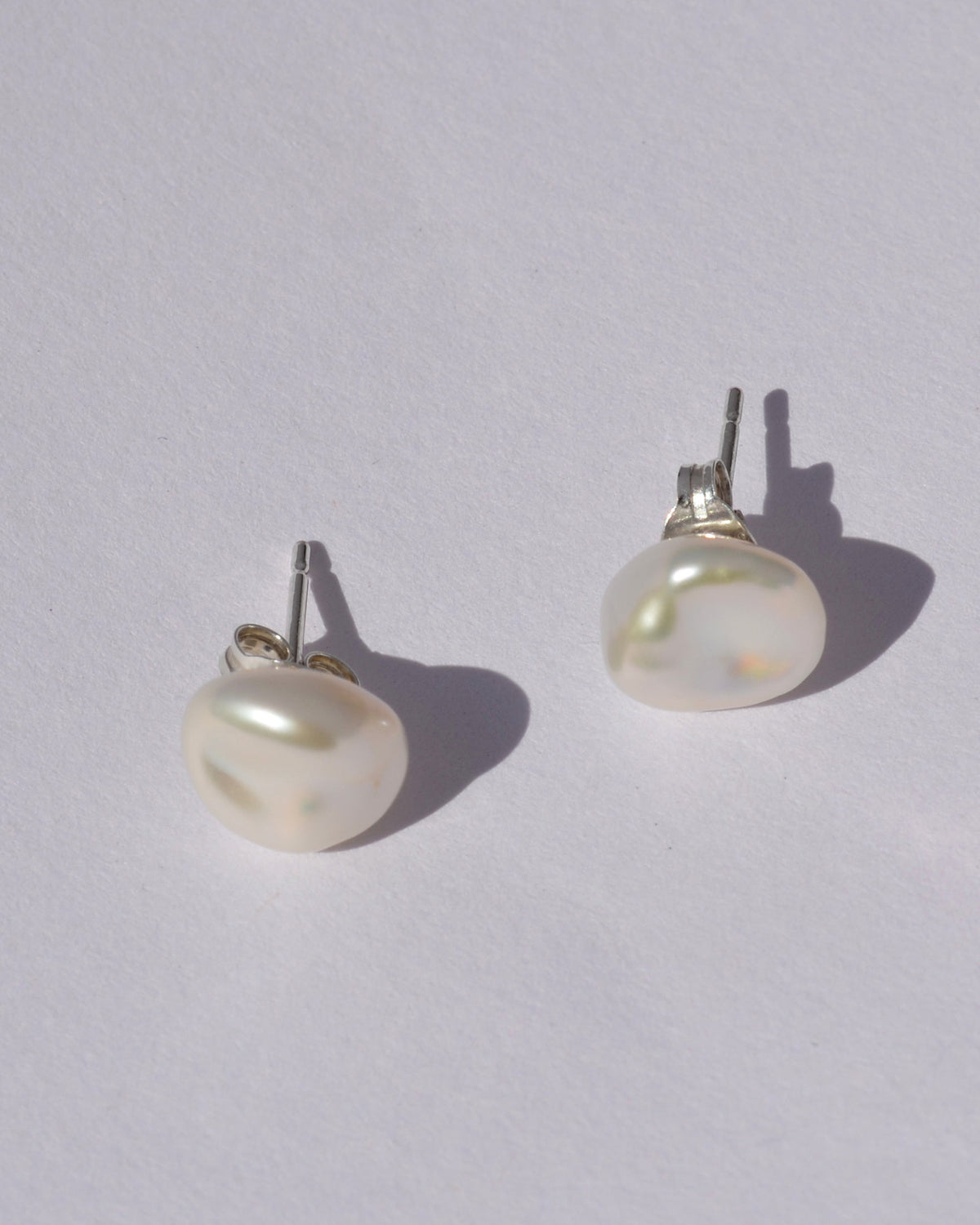 Pearl earrings on a light gray background